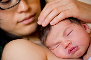 mother holding baby skin to skin