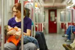 mother breastfeeding on subway