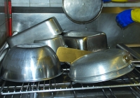 A picture of the dishes laying on a large drying rack.