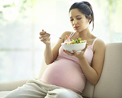 Photo of pregnant woman eating a salad