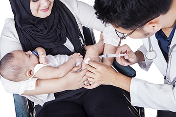 Photo of a baby being vaccinated