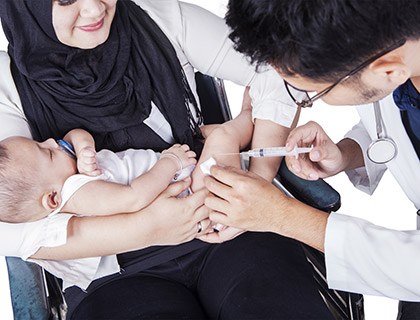 Photo of a baby receiving vaccine injection