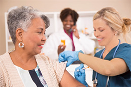 Photo of elderly woman getting flu shot