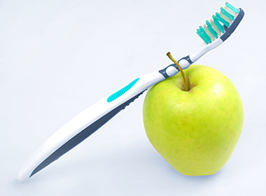 Photo of a toothbrush with an apple
