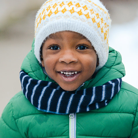 A young boy dressed warmly for winter