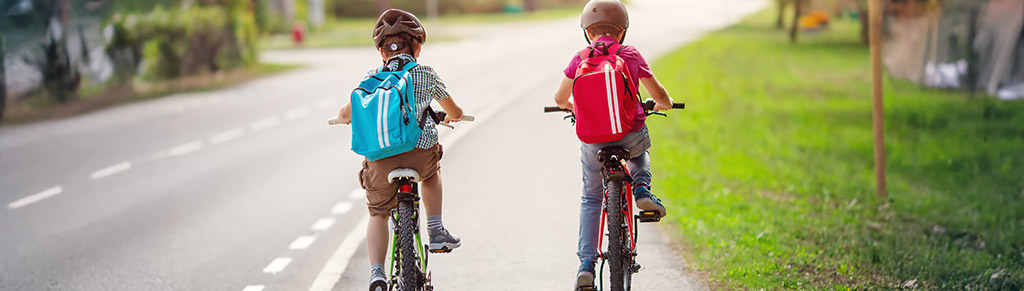 two kids ridding their bikes