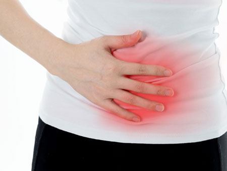 person holding stomach from abdominal pain