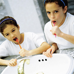 Photo of kids brushing their teeth